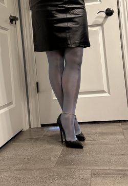 Blue nylons with black heels and leather pencil skirt